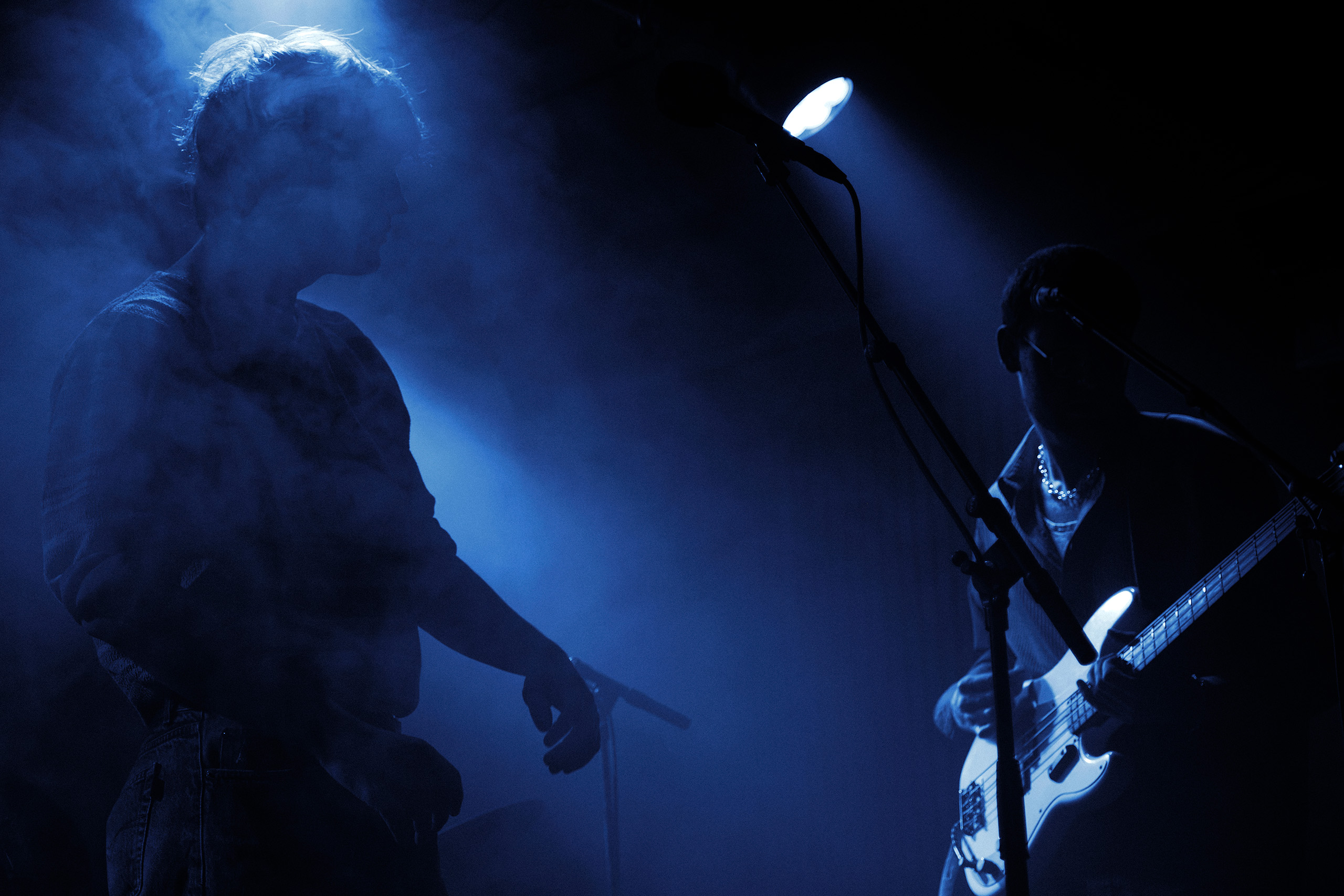 Silhouette of Thoughtfool performing live at Rust in Copenhagen with dramatic blue stage lighting.