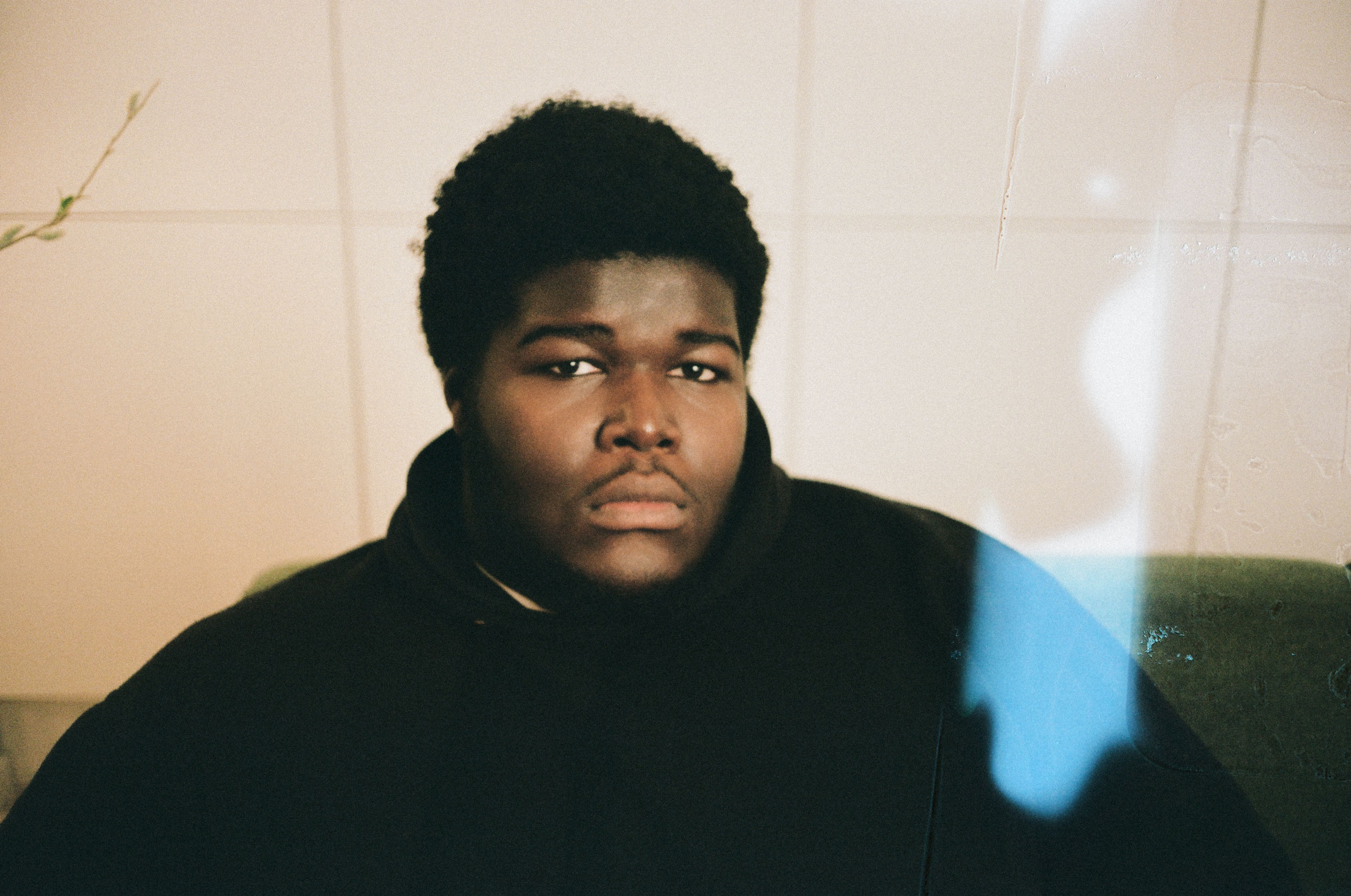 Creative portrait of Danish artist BUKURU with cinematic light leaks in an editorial photoshoot.