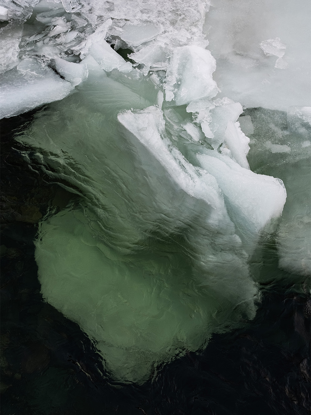 Floating ice in emerald green water in Norway photographed by Patrick Pankalla.