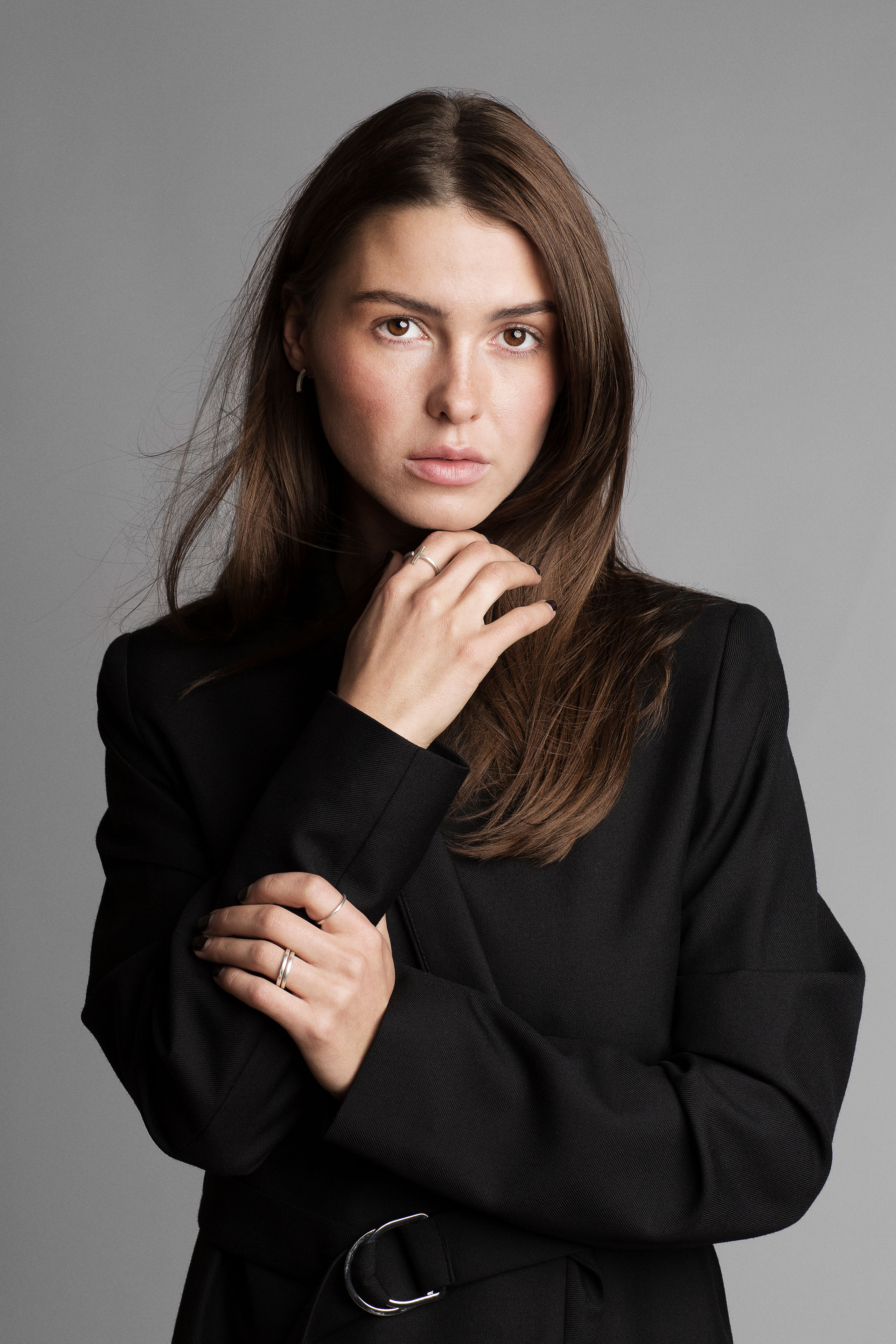 Fashion portrait of Sophia Roe wearing silver jewellery from the PERSUEDE Copenhagen campaign against a clean grey studio background.