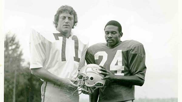 Steve Niehaus posing in his uniform with his teammate.