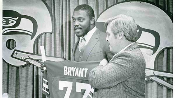 Jeff Bryant holding up his jersey after getting drafted