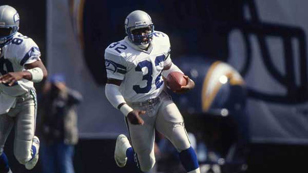John L Williams running with the football on the field