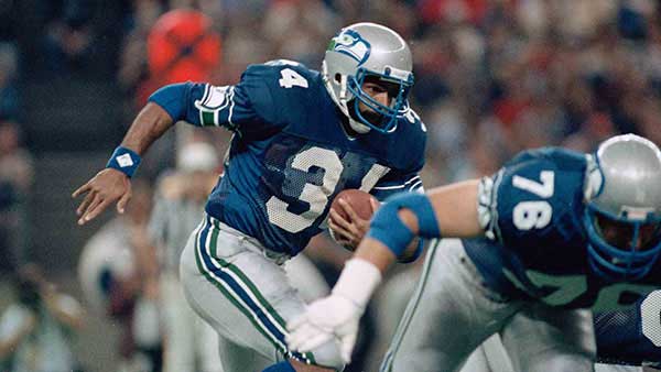Franco Harris running in Seahawks jersey and helmet