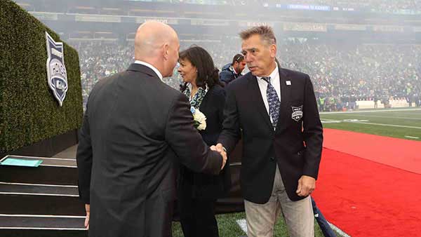 Jim Zorn in a suit shaking someone's hand