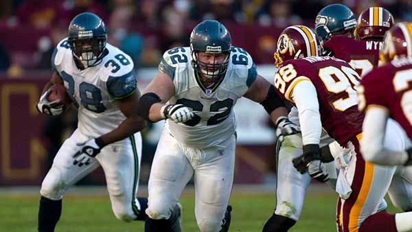 Chris Gray leading a block on the field