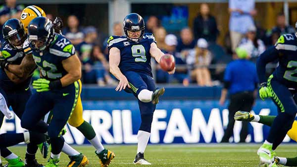 Jon Ryan punting a football