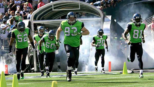Players entering field wearing neon-green jersey
