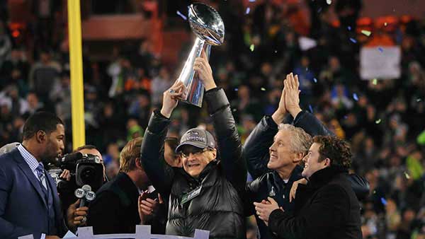 Paul Allen raising Super Bowl trophy