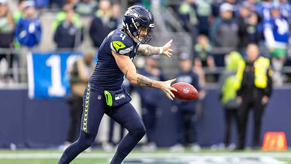 Michael Dickson punting a football