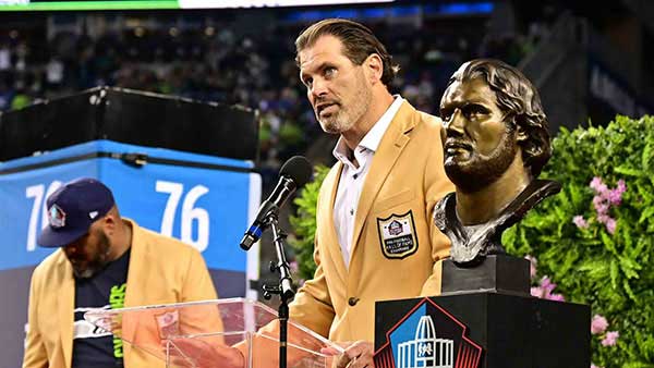 Steve Hutchinson next to his Hall of Fame Bust