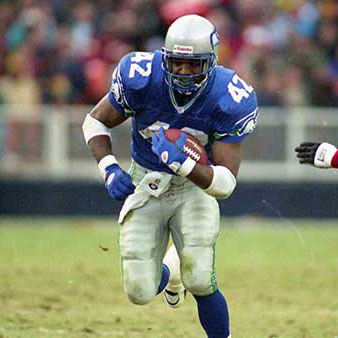 Chris Warren running on the field carrying the football