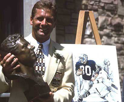 Steve Largent smiling with his Hall of Fame bust 
