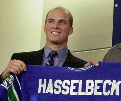 Matt Hasselbeck holding up his new Seahawks jersey 