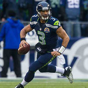 Russell Wilson running with the football, ready to throw