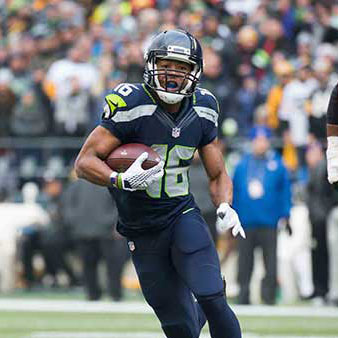 Tyler Lockett running from a defender