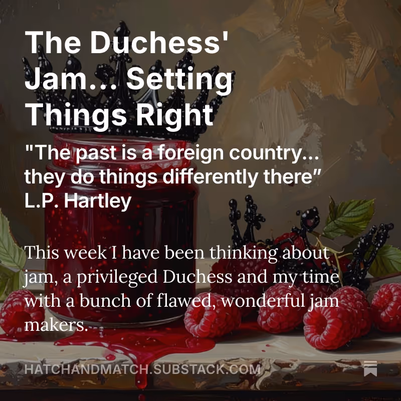 A jar of raspberry jam sitting next to a black crown.