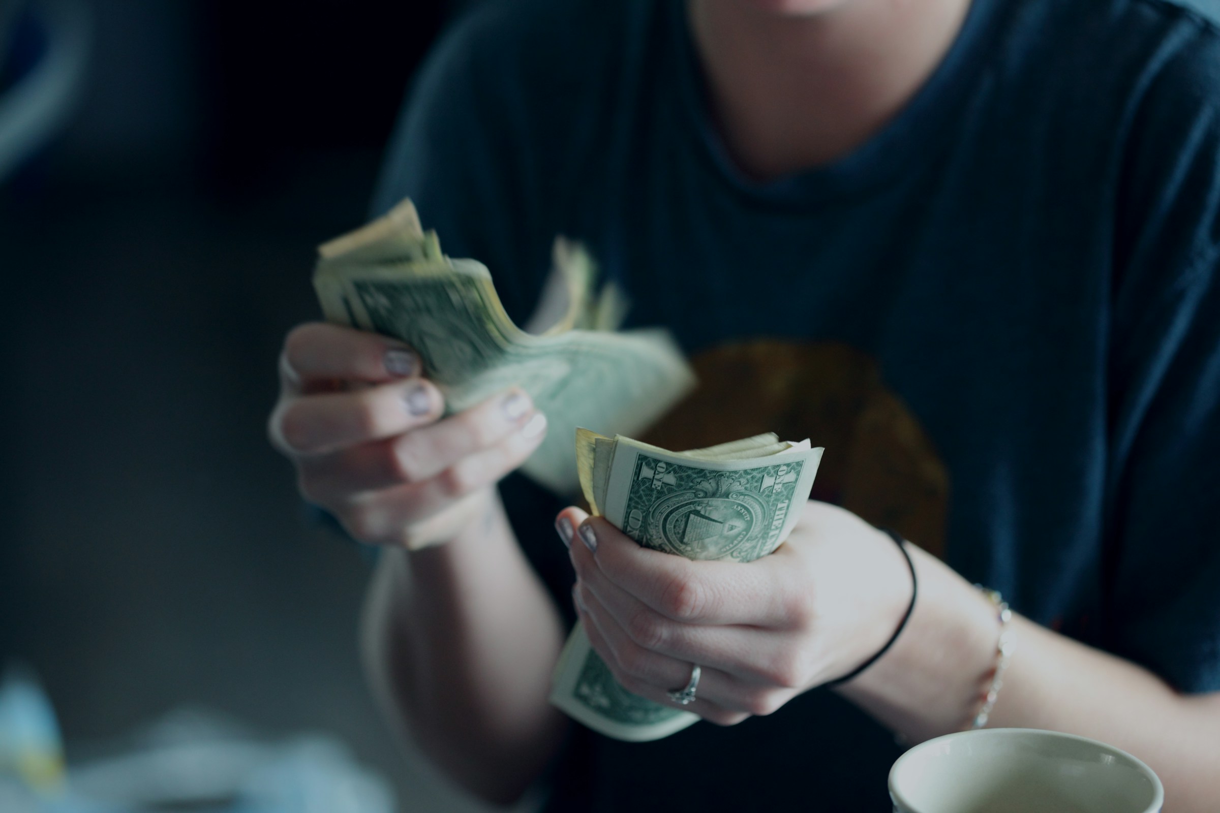 Person Holding Money - Is Day Trading Profitable