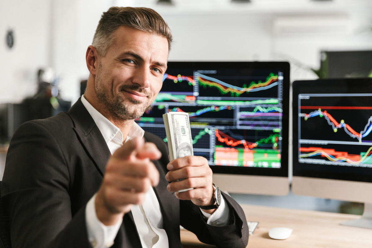man holding money - Day Trading Goals