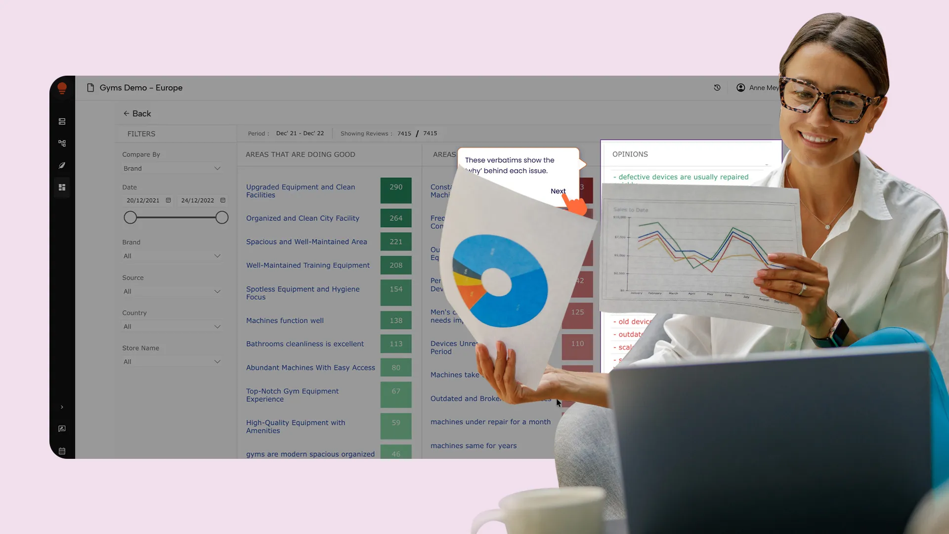Woman with glasses holding a paper showing a sales line graph and a pie chart, smiling while working on a laptop with data dashboard on gym equipment performance in the background.