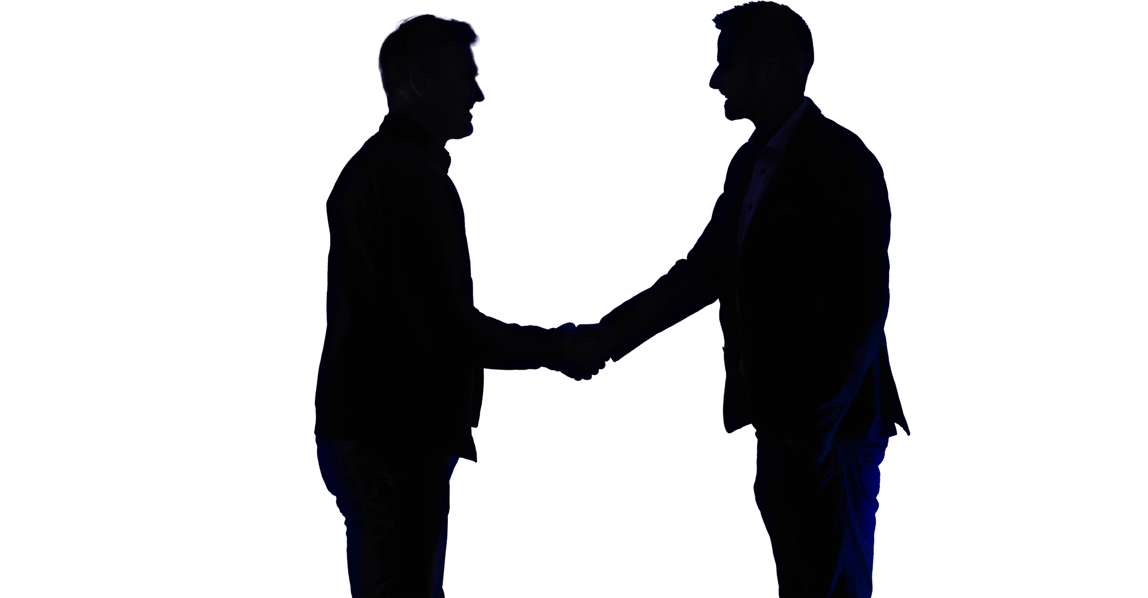 Silhouettes of two people shaking hands