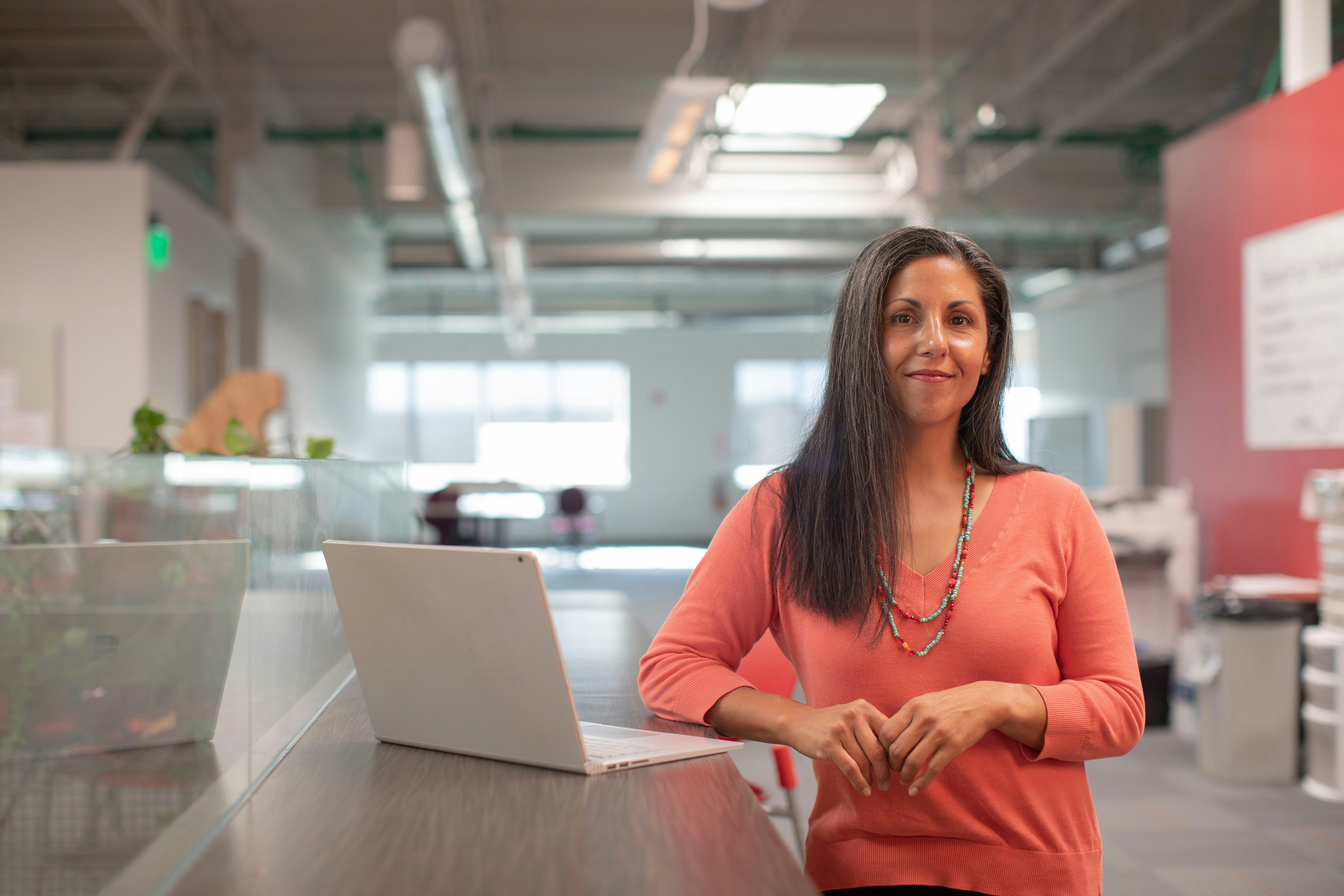 Senior leader with laptop in a contemporary workplace