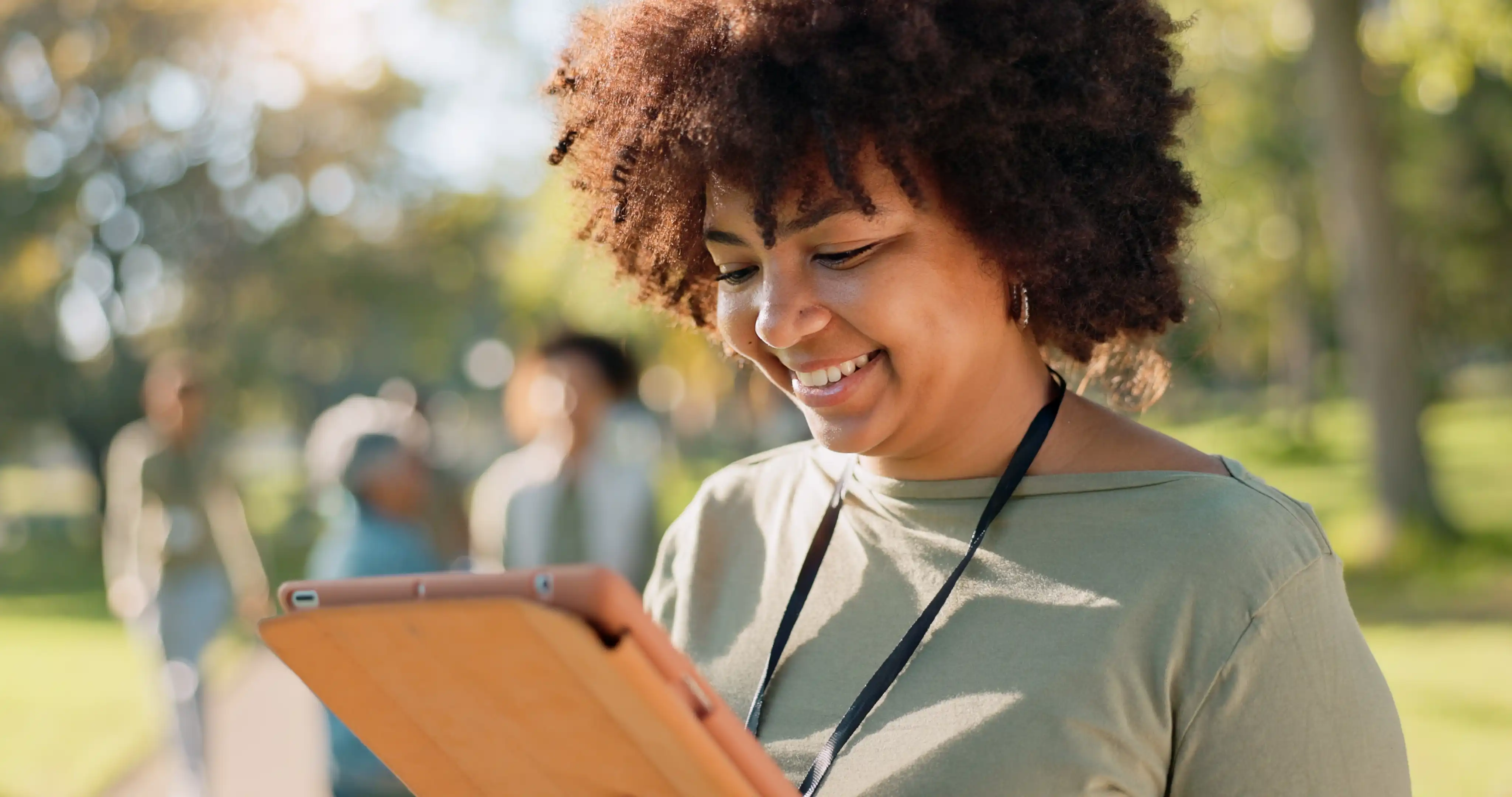 Woman, volunteer and happy nature with tablet in outdoor, community work and environment sustainability project with group. Recycle, waste management and cleaning outside trash, help and ngo support