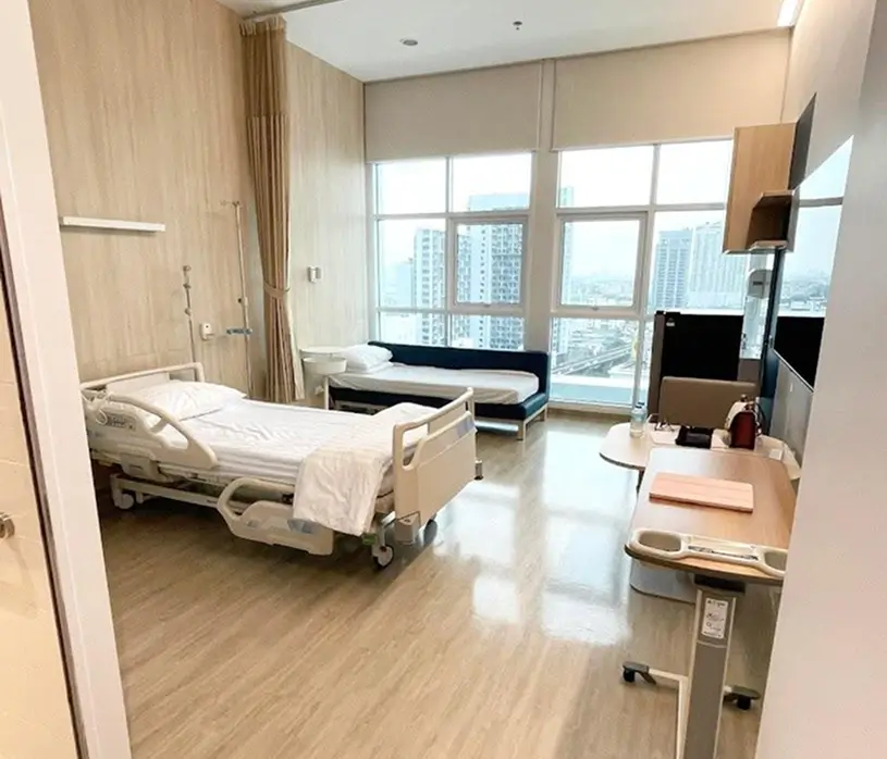 Patient room with city view and hospital bed