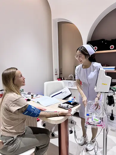 Woman in pink robe consulting doctor

