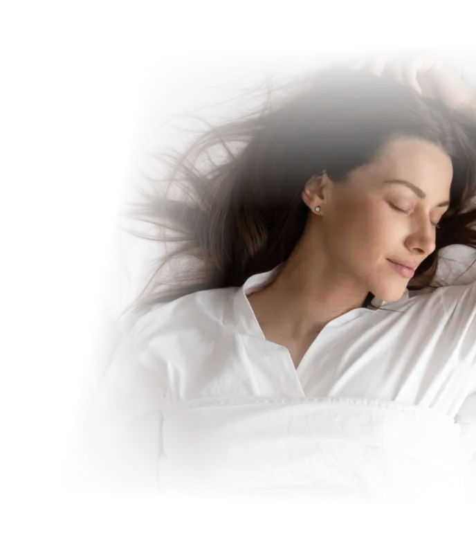 Woman peacefully resting in bed with eyes closed