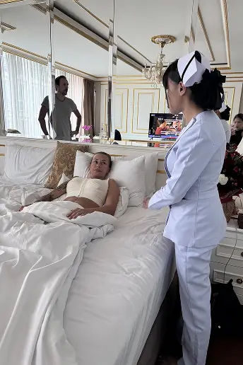 Nurse caring for patient in luxury room