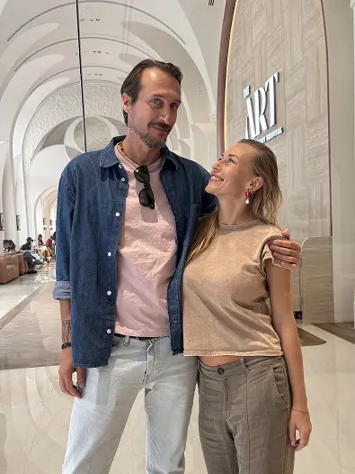 Couple smiling in modern hospital corridor

