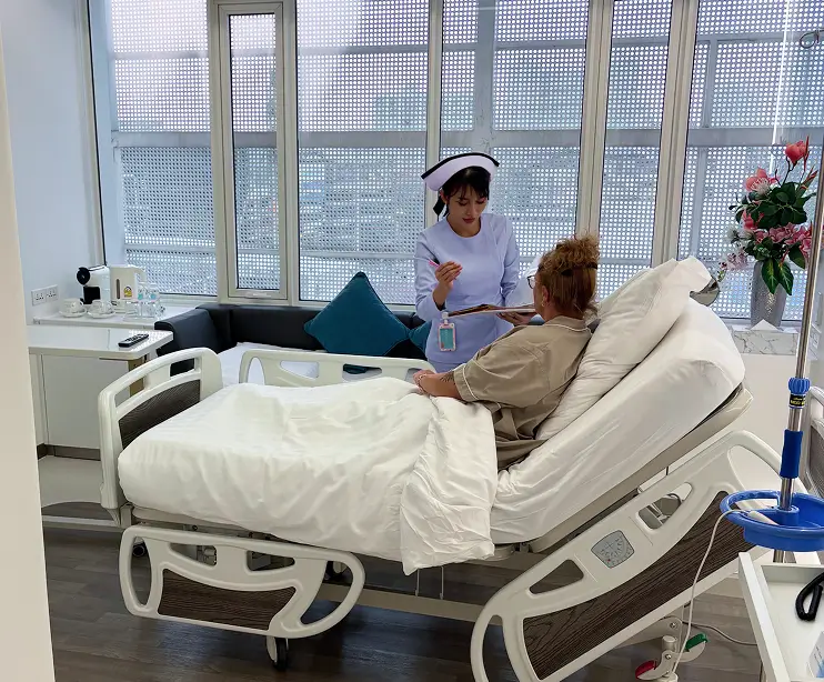 Patient lying in hospital bed with city view

