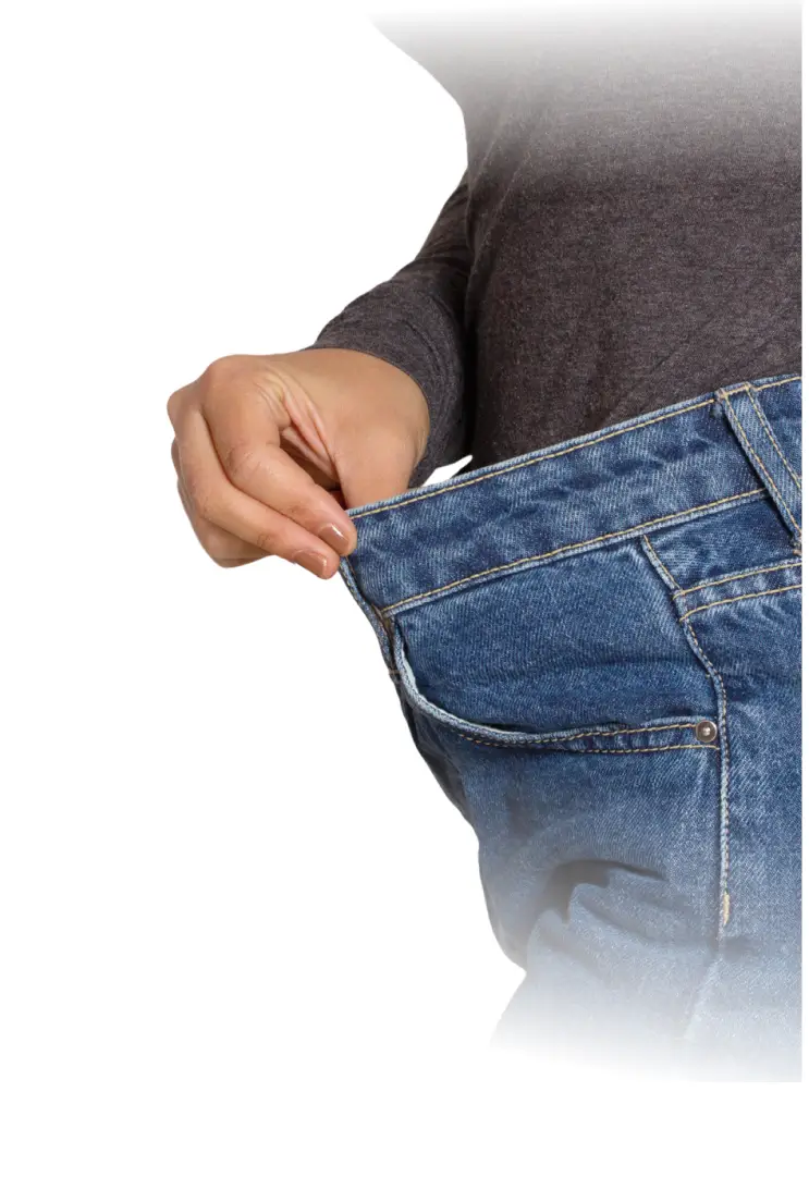 Person pulling on loose jeans at waist


