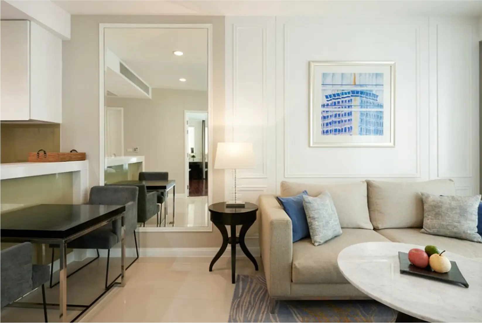 Stylish living room with beige sofa, coffee table, and wall art.