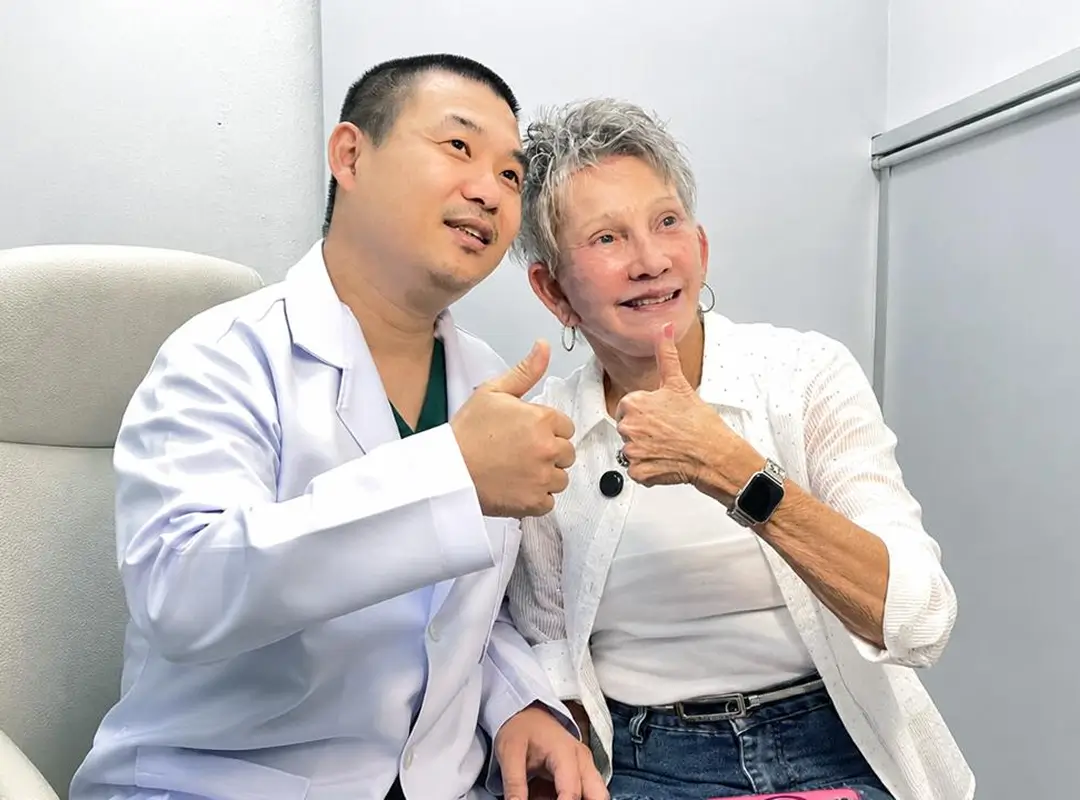 Surgeon reviewing progress with a patient at a follow-up consultation