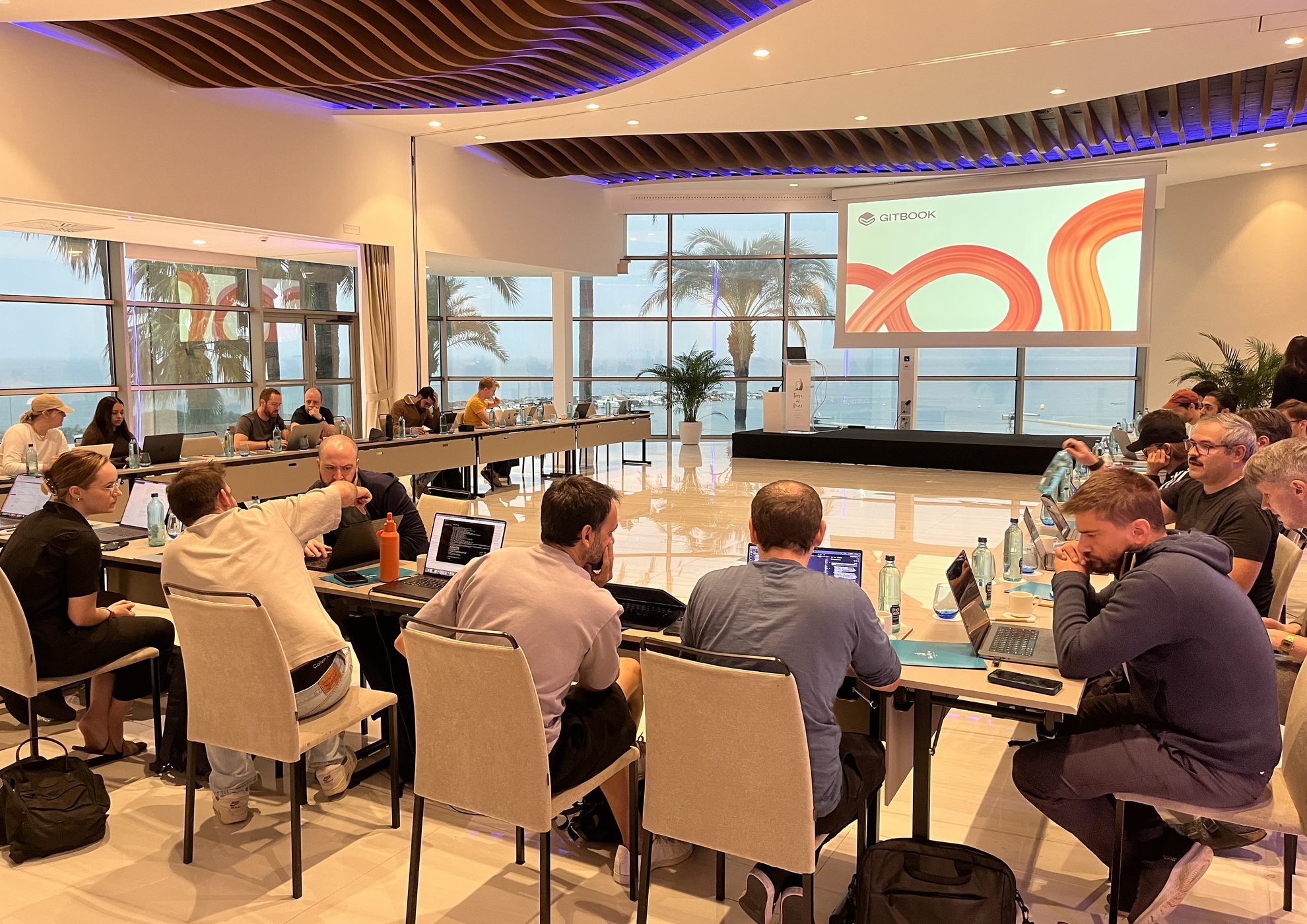GitBook team work session in a sea-view meeting room during their offsite