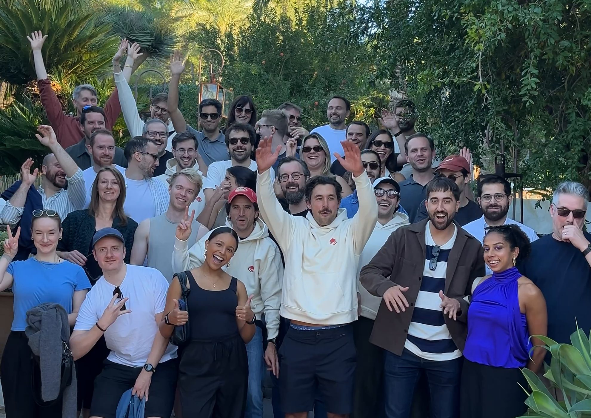 GitBook team cheering in the gardens of Atzaró Agroturismo