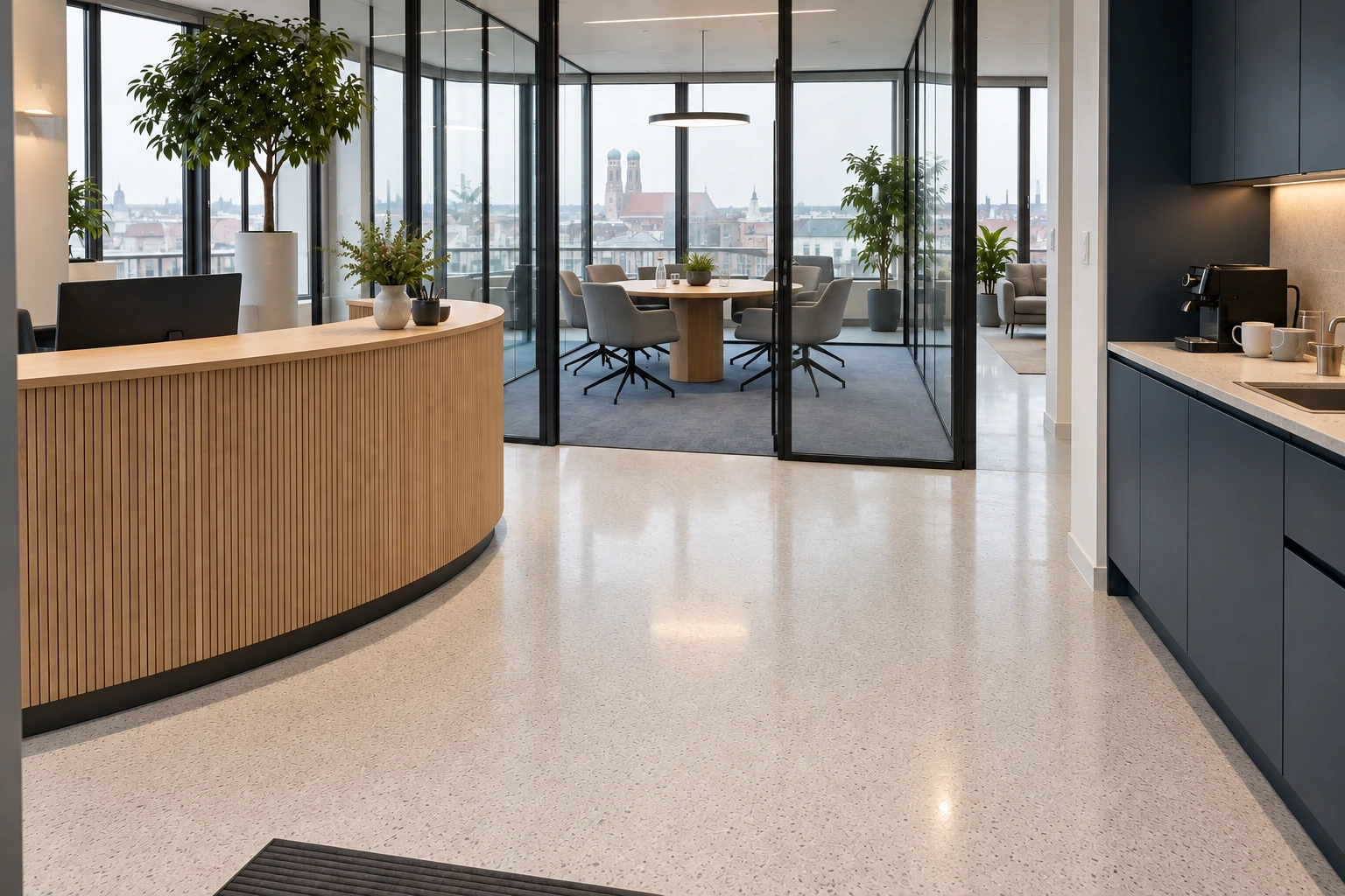 Illustrativ gereinigtes und zur Übergabe vorbereitetes Büro mit trockenem streifenfreiem Terrazzo, klarem Glas, sauberer Teeküche, aufgefrischtem Teppich und ordentlich zurückgestellten Stühlen