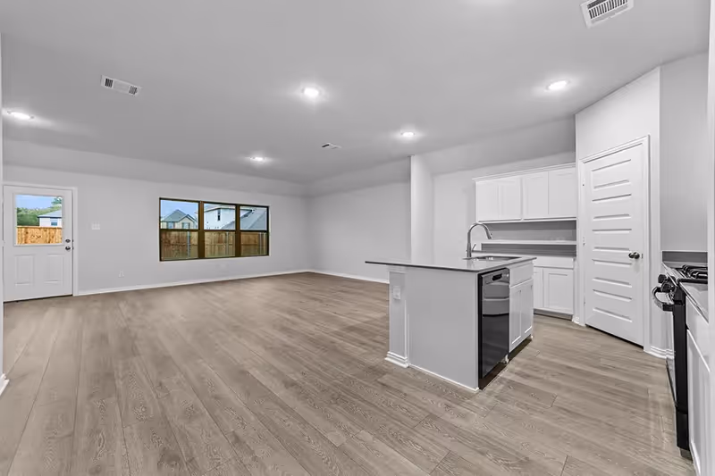 Vinyl floors with living room and kitchen open layout, 3 windows and a back door