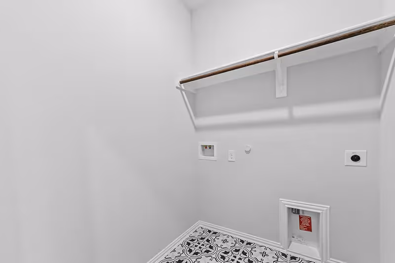 Laundry room with clothing bar and printed tile