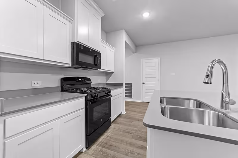 black appliances and close up of the counters with stainless steel sink