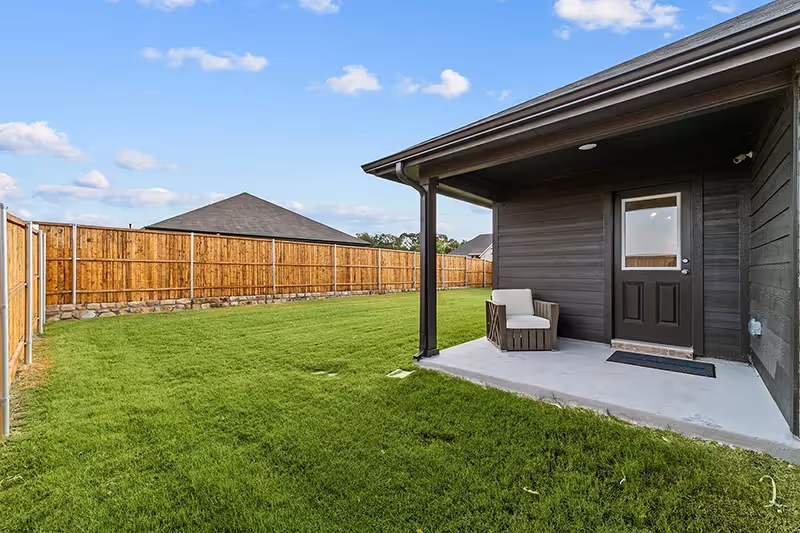 covered back patio with grass