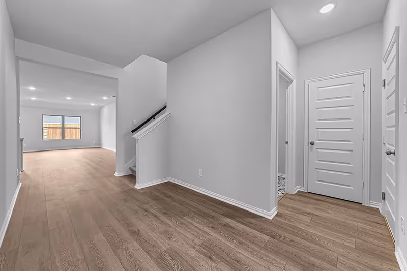 hallway entrance into house including stairs