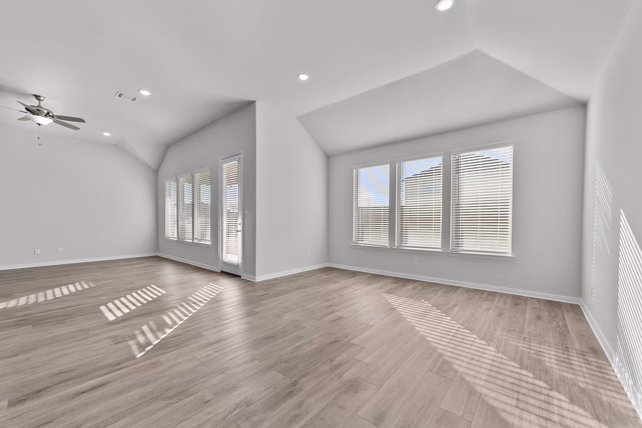 Living room with windows and back door shown