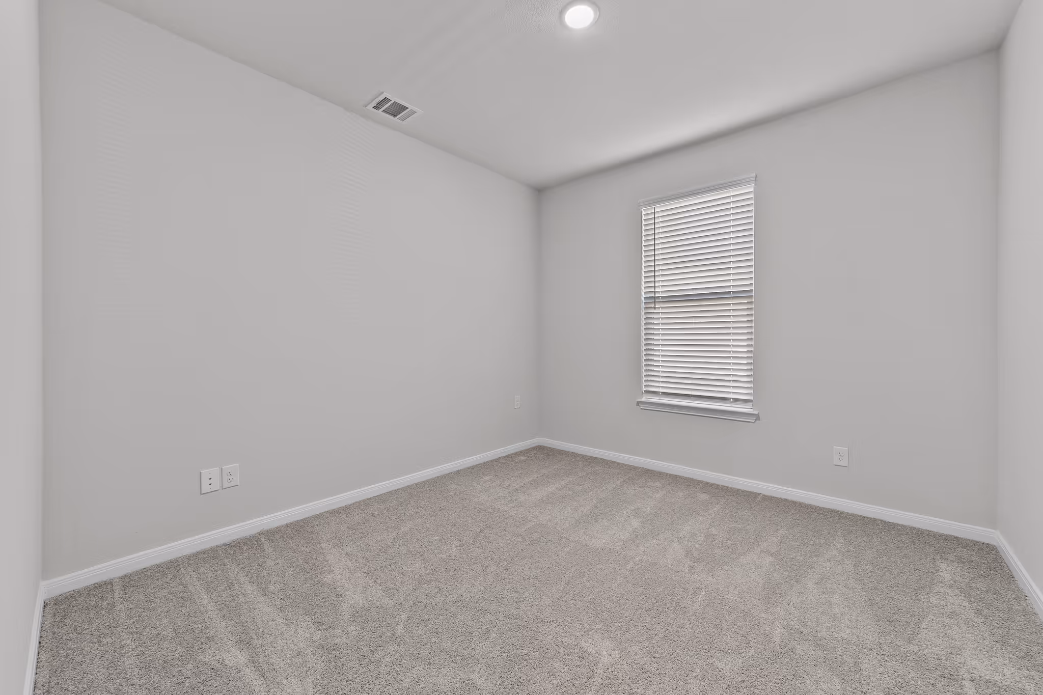bedroom 1 with carpet and a window shown