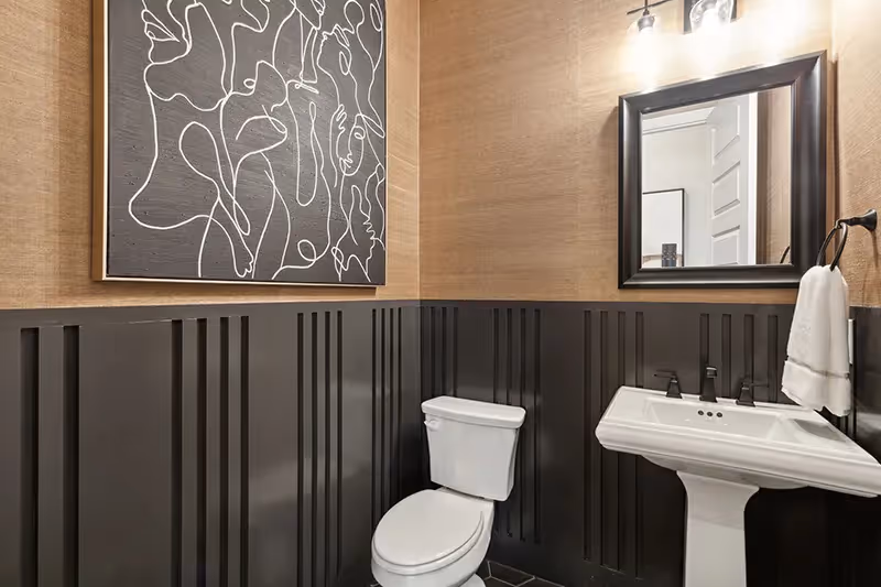 powder bathroom with single sink and toilet