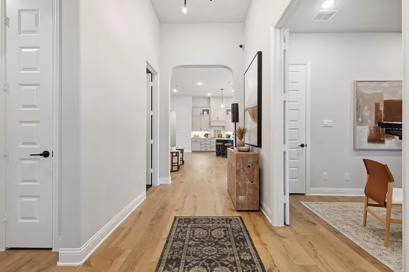 entry hallway with high ceilings opening to the study right away