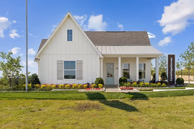 Outside photo of the lake park birchwood model, white siding with grassy lawn and landscaping