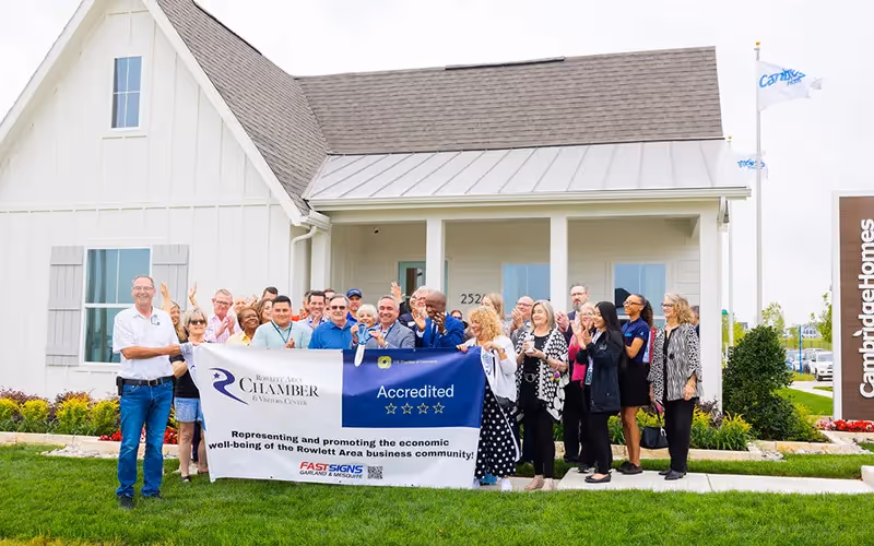 photo of ribbon cutting in lake park with lots of people